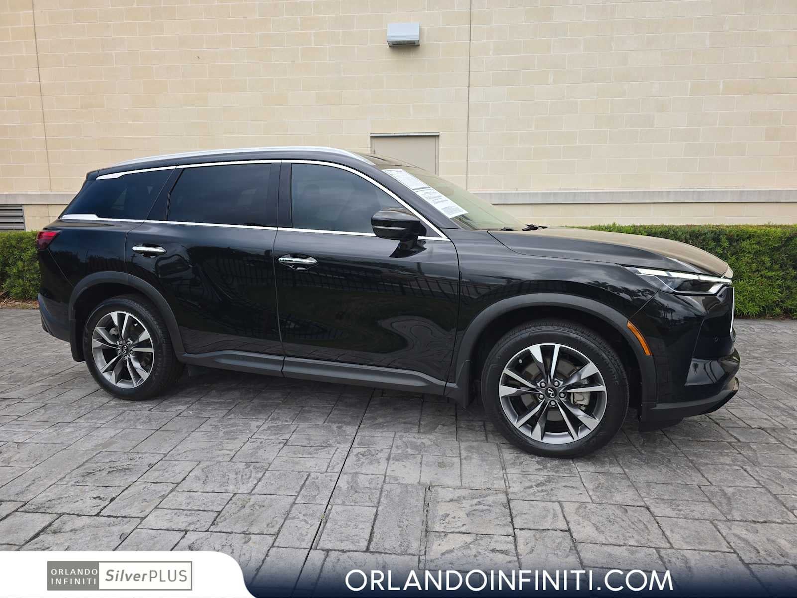 2023 INFINITI QX60 LUXE in Mineral Black — front three-quarter view